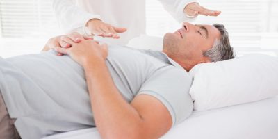 Therapist working with man in medical office